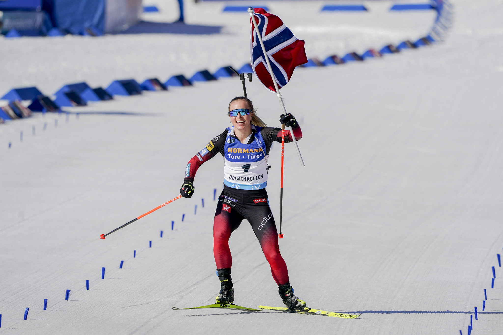 Tiril Eckhoff of Norway celebrates the victory with her country's flag during the women's 10km pursuit event at the IBU Biathlon World Cup in Holmenkollen ©Getty Images