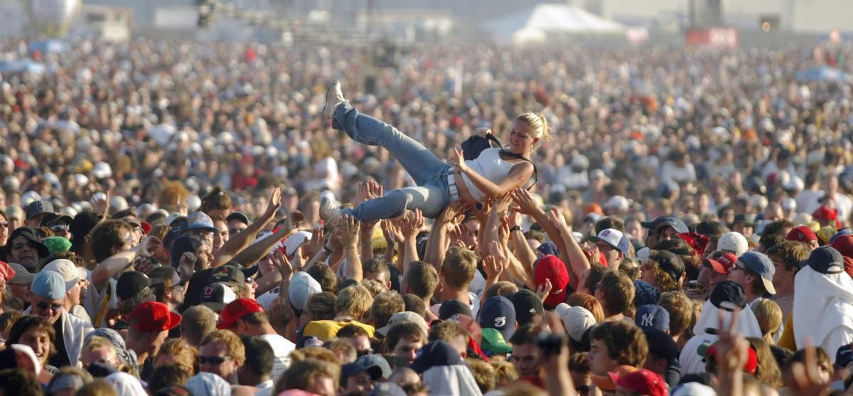 Fans cool off at the largest outdoor ticketed concert in North America at Downsview in Toronto, July 30, 2003.